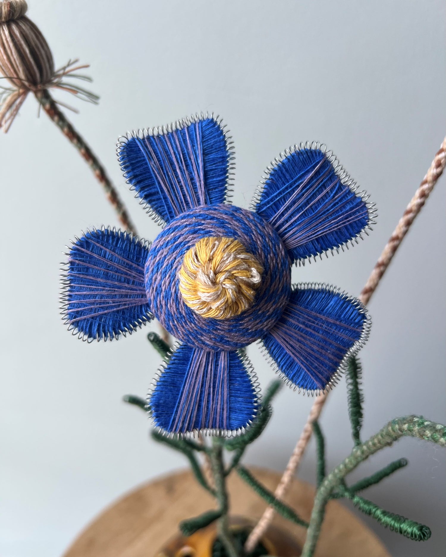 A blue and yellow passementerie flower